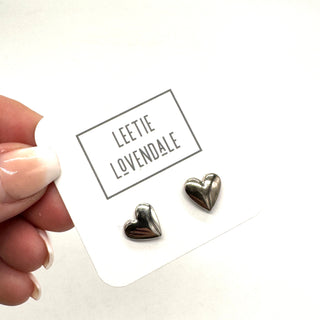 Heart-shaped earrings on a card with 'LEETIE LOVENDALE' branding.