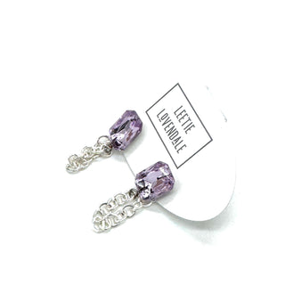 Pair of purple crystal earrings with silver chains on a white background, featuring a 'Leelee Lavendale' label.