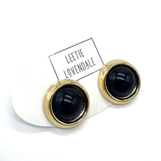 Black and gold earrings on a white background with 'Lectie Lovendale' card.