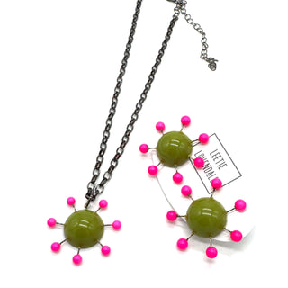 Olive green pendant with hot pink beads radiating around the center, reminiscent of the Sputnik satellite. Pendant hangs on an adjustable chain, matching earrings are shown alongside.