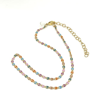 A golden chain necklace with colorful enameled links on a white background.