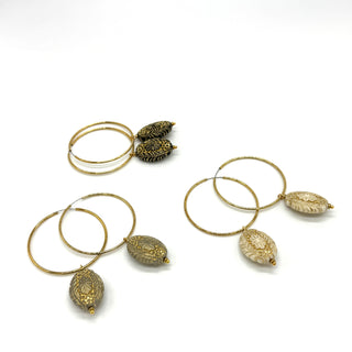 Three pairs of hoop earrings with dangles on a white background.