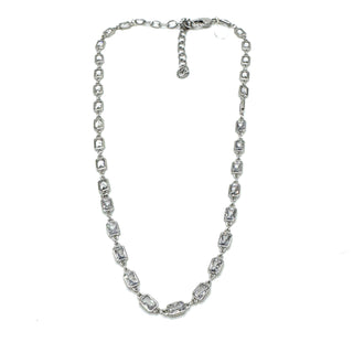 Silver necklace with clear stones on a white background