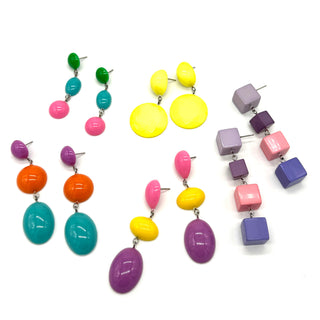 Colorful earrings with various shapes on a white background