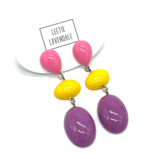 Colorful earrings with pink, yellow, and purple beads on a white background with 'Leetie Lovendale' branding.