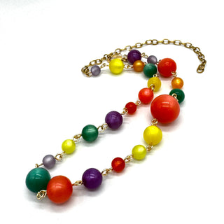 Colorful beaded necklace with a gold chain on a white background