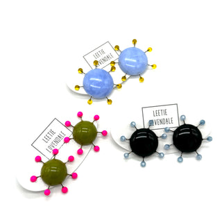 Colorful sculptural earrings with 'Leetie Lovendale' labels on a white background