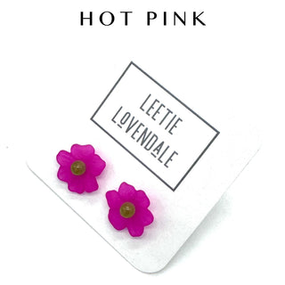 Hot pink flower stud earrings on a white background