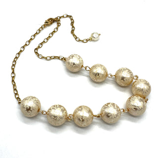 Half chain and half beaded necklace, featuring gold chain and floral etched pearl lucite beads.