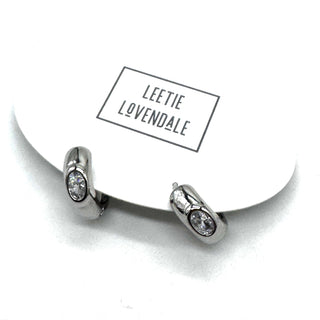 Silver and crystal hoop earrings on an earring card.