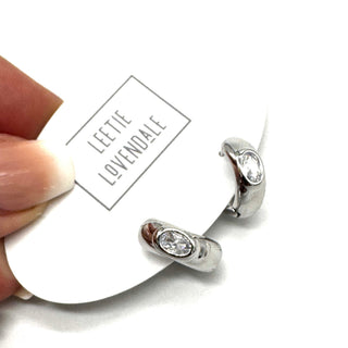 Silver and crystal hoop earrings on an earring card.
