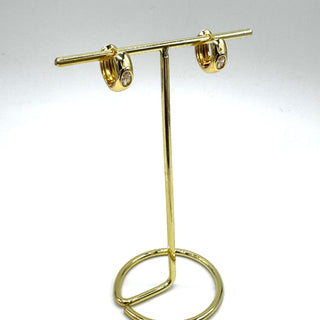 Gold and crystal hoop earrings on a gold stand.
