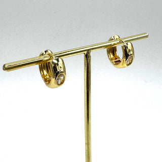 Gold hoop earrings with a crystal set in the center of each.