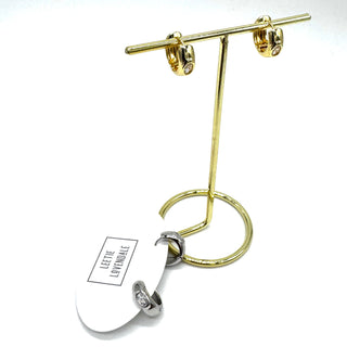 Gold and crystal hoop earrings on a gold stand, and silver and crystal hoop earrings on an earring card.