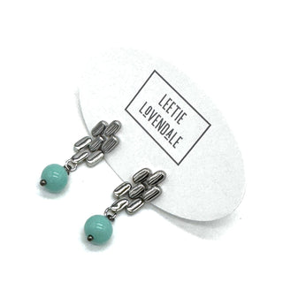 Silver drop earrings with a turquoise glass bead.