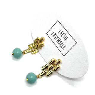 Gold drop earrings with a turquoise glass bead.