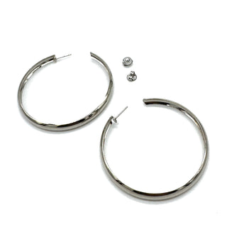 Large silver hoop earrings on a white background.