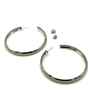 Large silver hoop earrings on a white background.