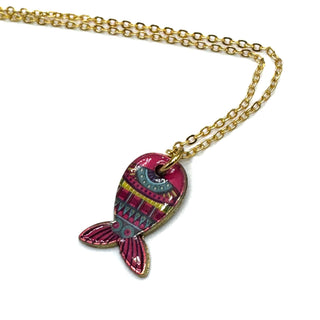 A gold chain necklace featuring a colorful fish-shaped pendant with pink, teal, and yellow patterns, set against a plain white background.