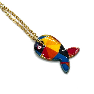 A gold chain necklace with a colorful fish-shaped pendant featuring a geometric pattern of red, orange, yellow, blue, and black, set against a plain white background.