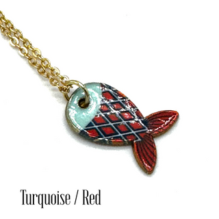 A gold chain necklace with a fish-shaped pendant featuring a turquoise and red plaid pattern, shown on a white background with the text 'Turquoise / Red' at the bottom.