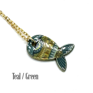 A gold chain necklace with a stylized fish pendant featuring teal, green, and gold mosaic detailing, shown on a white background with the text 'Teal / Green' below.