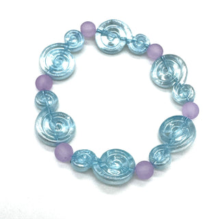 A beaded stretch bracelet featuring light blue translucent spiral-shaped beads and small matte lavender-purple round beads, displayed on a clean white background.