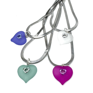 Four heart-shaped pendant necklaces with silver snake chains on a plain white background.