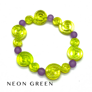 A beaded stretch bracelet featuring translucent neon green spiral-shaped beads and matte purple round beads, displayed on a white background with the text 'NEON GREEN' underneath.