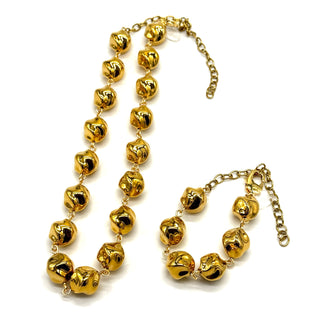 Gold-tone beaded necklace and matching bracelet set with shiny, reflective round beads and chain links, displayed on a clean white background.