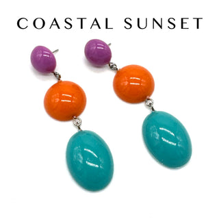 Colorful earrings with purple, orange, and teal beads on a white background.