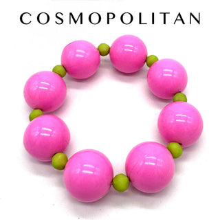 Pink and green beaded bracelet on a white background with 'Cosmopolitan' branding.